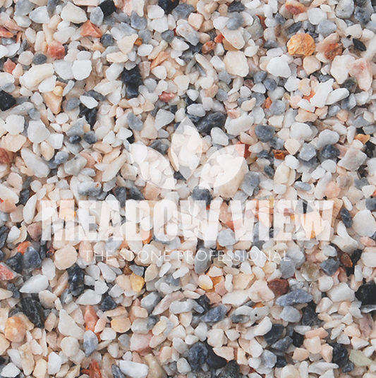 A close-up of multicolored gravel with the overlaid text "PAVING SHOPPER ALPINE FLAMINGO CHIPPINGS - 3-8mm.