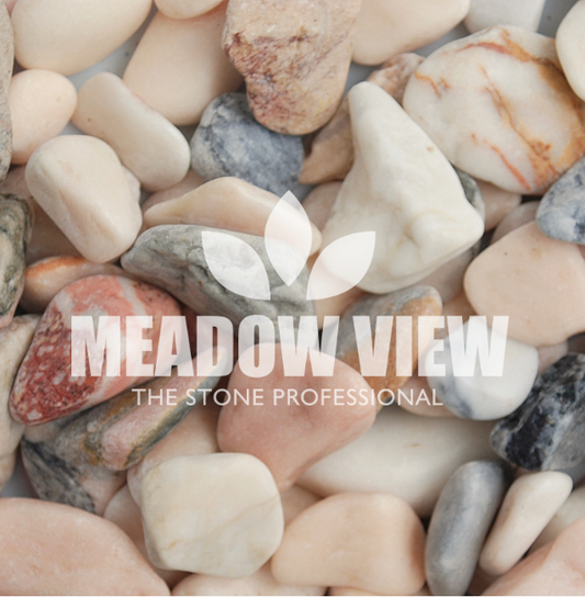 Close-up image of assorted polished Flamingo Pebbles - 20-50mm in various shapes and colors with the "Paving Shopper" logo placed centrally on top of the pebbles.