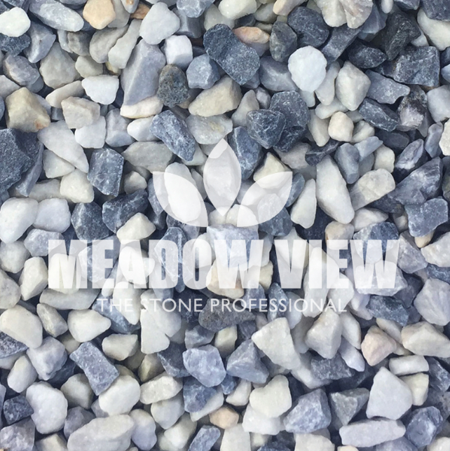 A close-up view of variously sized white, gray, and black pebbles labeled with the Paving Shopper logo and the text "THE STONE PROFESSIONAL" superimposed on them, featuring the Polar Ice Chippings - 20mm.