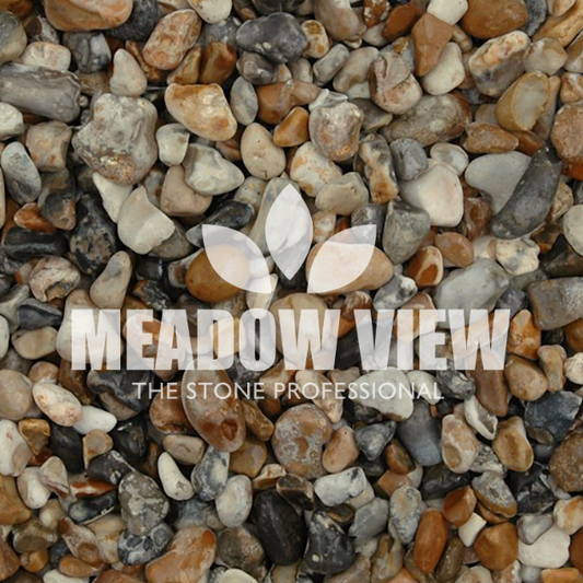 A blend of differently colored small stones labeled "PAVING SHOPPER SEASHORE CHIPPINGS - 10-20MM" in white, with a leaf-shaped logo positioned above the text.