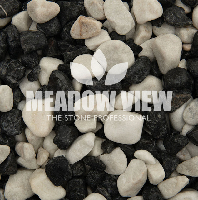 A mix of small white and black Zebra Pebbles (15-25mm) from Paving Shopper, featuring a text overlay with "MEADOW VIEW The Stone Professional" and accompanied by a leaf logo.